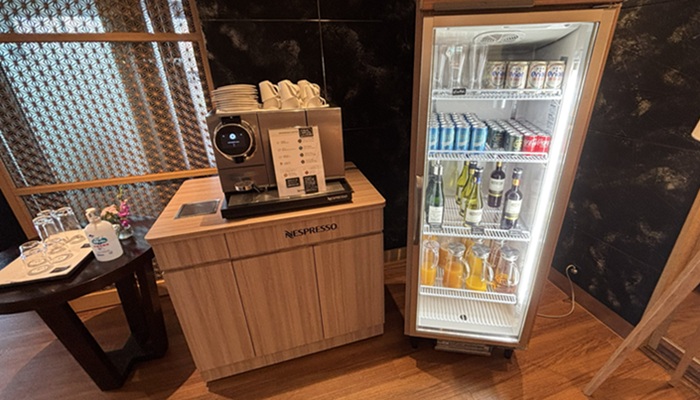 シギラミラージュ「ザ クラブラウンジ」のドリンクコーナー。ネスプレッソのコーヒーマシンと、オリオンビール、シャンパン、ジュース類が並ぶ冷蔵庫